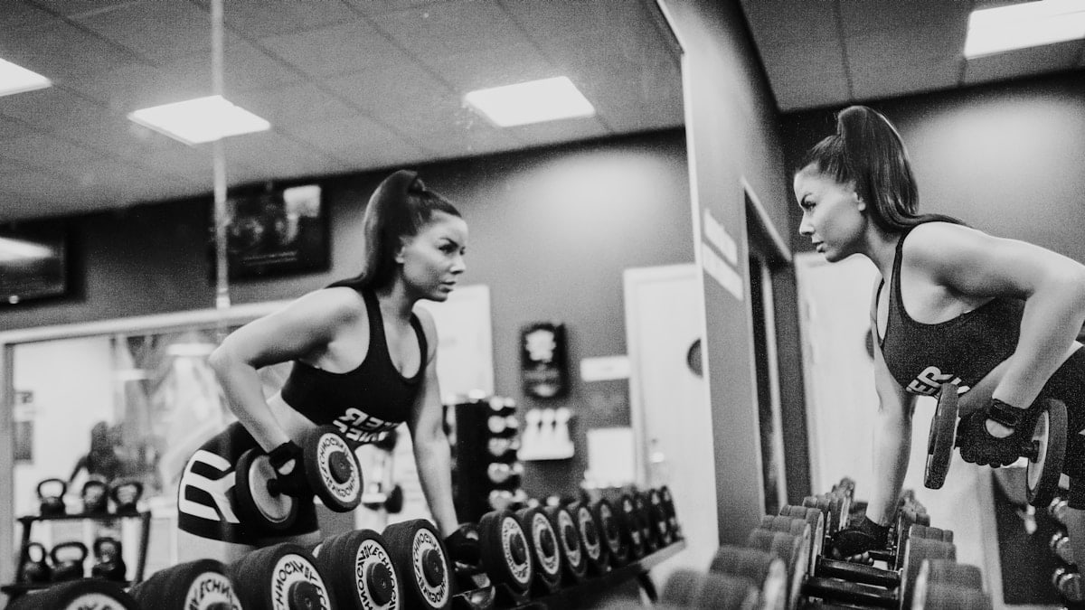 woman in black tank top and black shorts doing exercise
